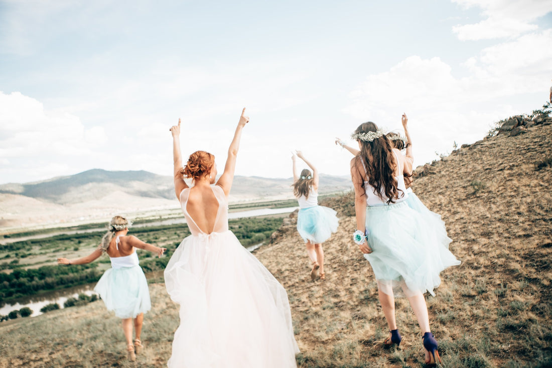 Bride and Bridesmaids celebrating wedding at the beach